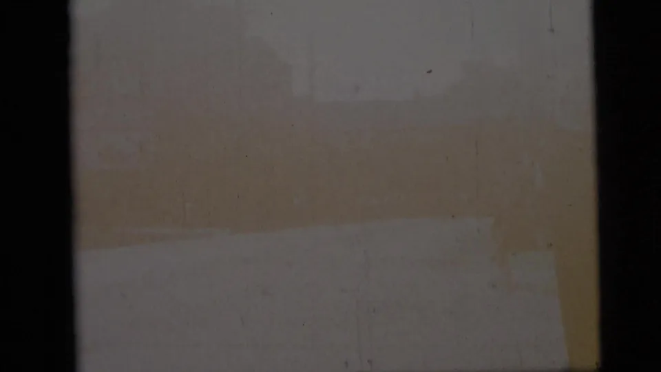 Start frame from a 1959 8mm Camden street clip, partly obscured by film edge or exposure with little street detail visible.