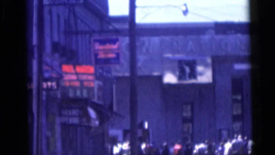 Camden commercial block with pedestrians clustered near bright signage and a broad building facade.
