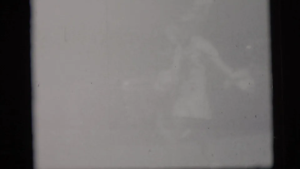 The final frame is mostly washed out, with a faint, indistinct figure visible through the overexposed 8mm image.