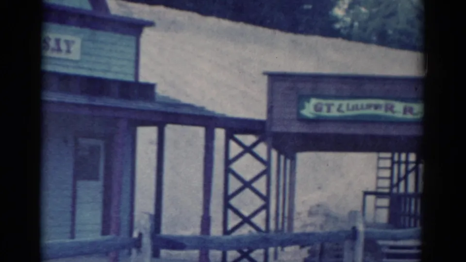 Catskill resort exterior in 1959 with a partially visible GT Lilliput R.R. sign, open porch structure, fence, and hillside.