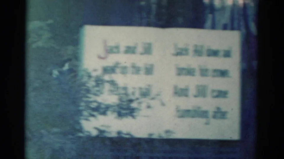 Handwritten Jack and Jill story sign in a 1959 Catskill 8mm frame, partly obscured and softened by film blur.