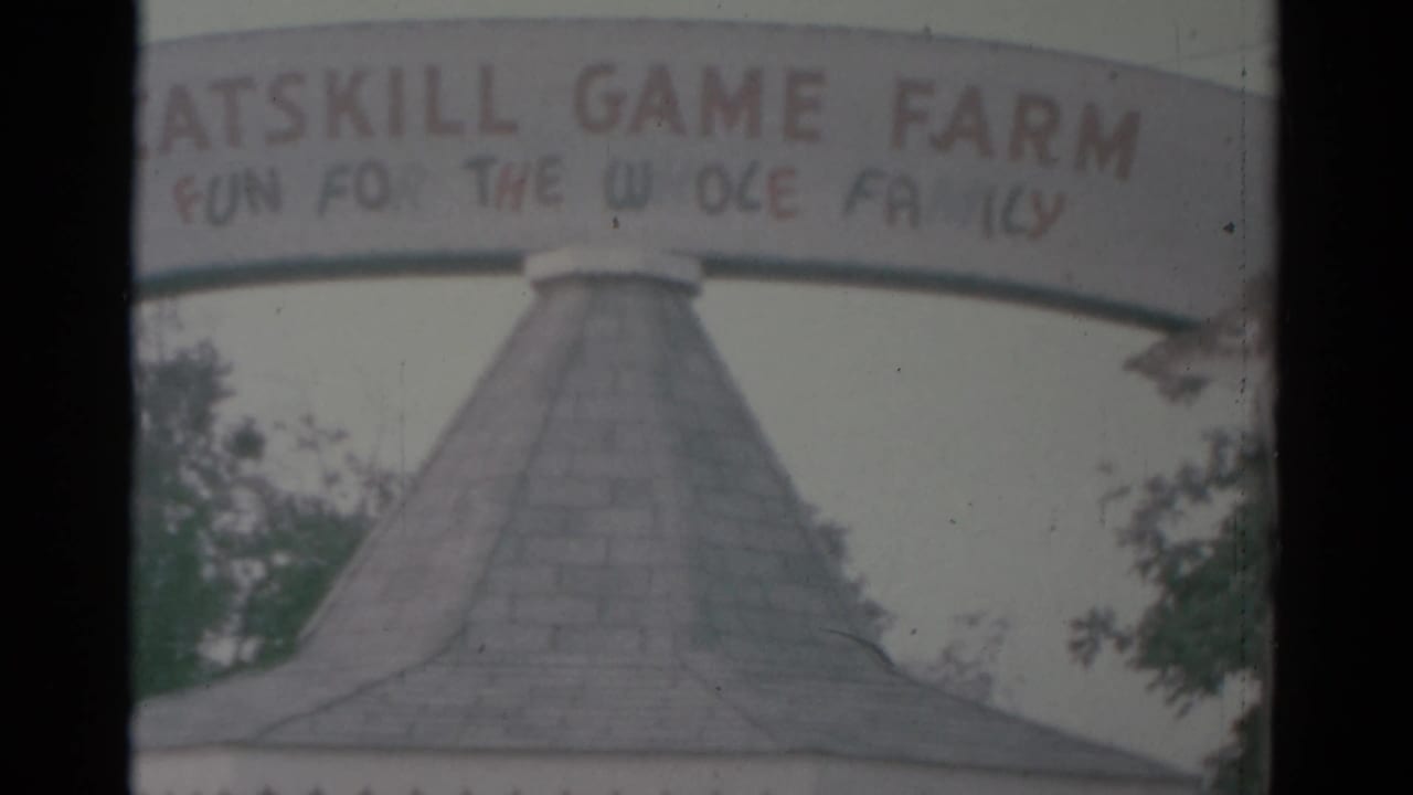 Entrance sign and shingled roof framed through 8mm film edges.