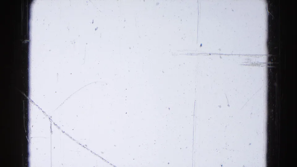 Hagerstown 1959 metadata frame showing a pale overexposed 8mm field with dark gate edges, scratches, dust, and faint vertical marks.