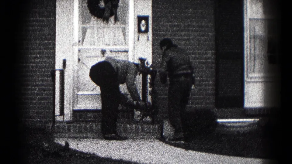 At the end of the clip, two men remain near the decorated front door of a brick Hagerstown home.