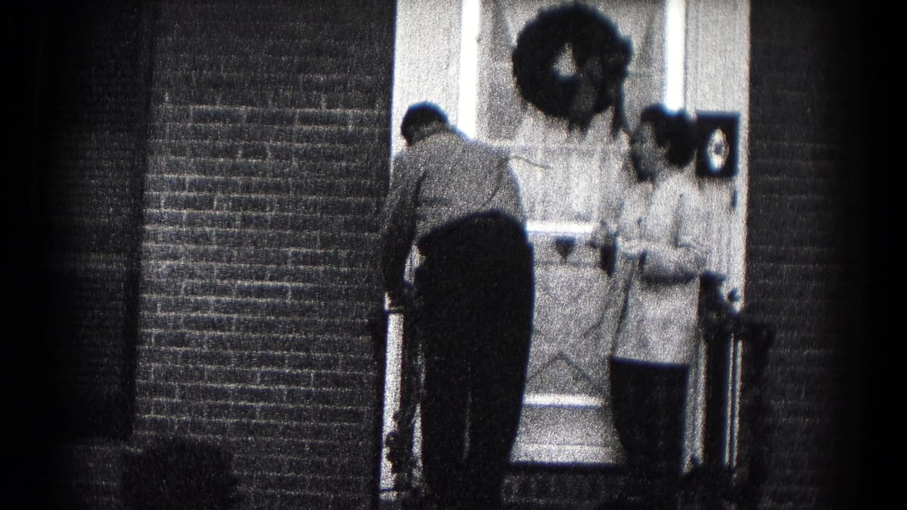 A 1959 Hagerstown residential doorway scene shows a man preparing to leave while a woman stands by the door.