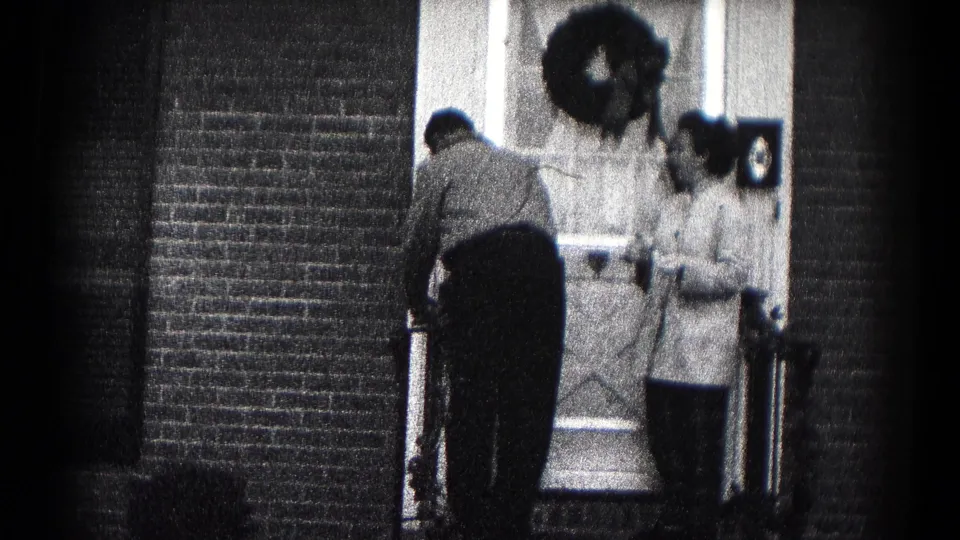 A 1959 Hagerstown residential doorway scene shows a man preparing to leave while a woman stands by the door.