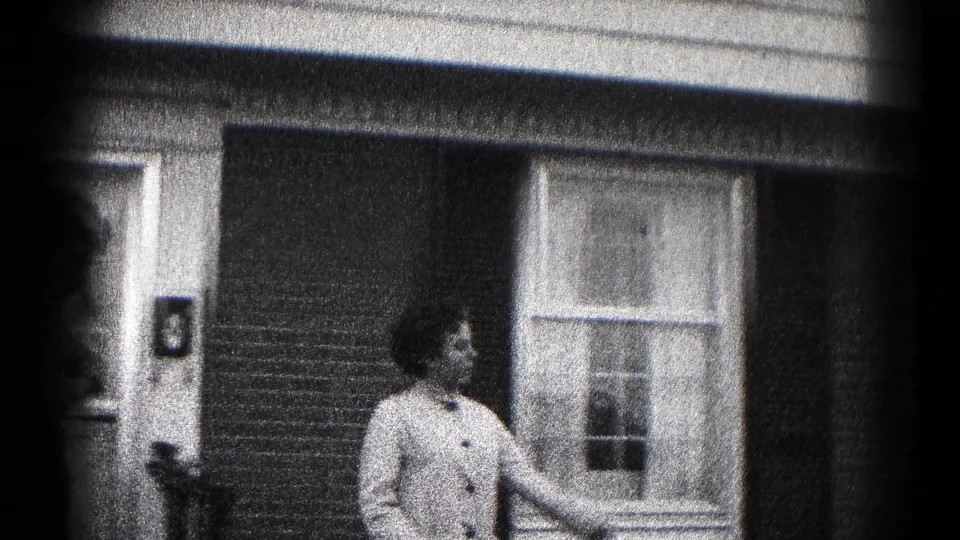 The woman stands alone on the porch area of a Hagerstown home after the doorway farewell.