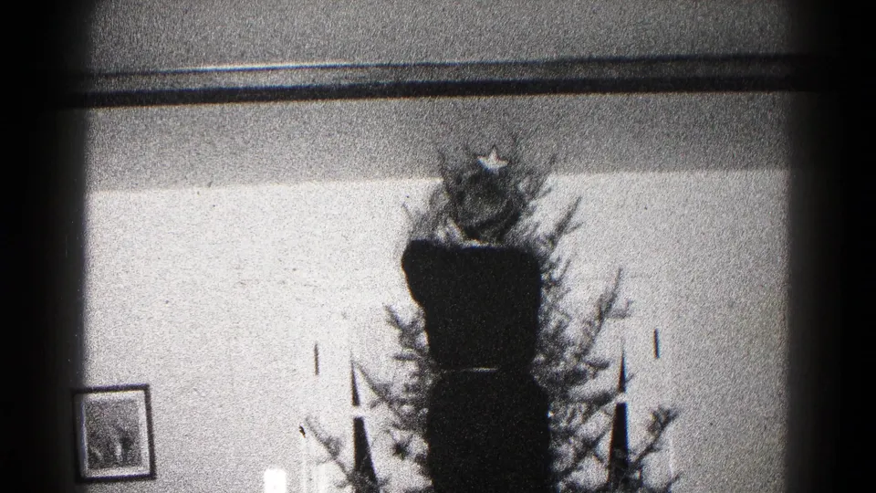 A 1959 Hagerstown interior shows a Christmas tree with a star topper, framed picture, and candle-like decorations.