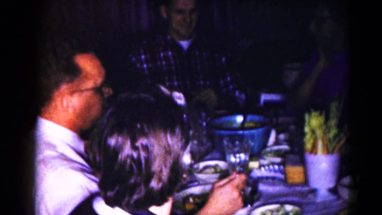1959 Hagerstown frame with adults at a dinner table, a large blue bowl, glasses, and celery sticks visible.