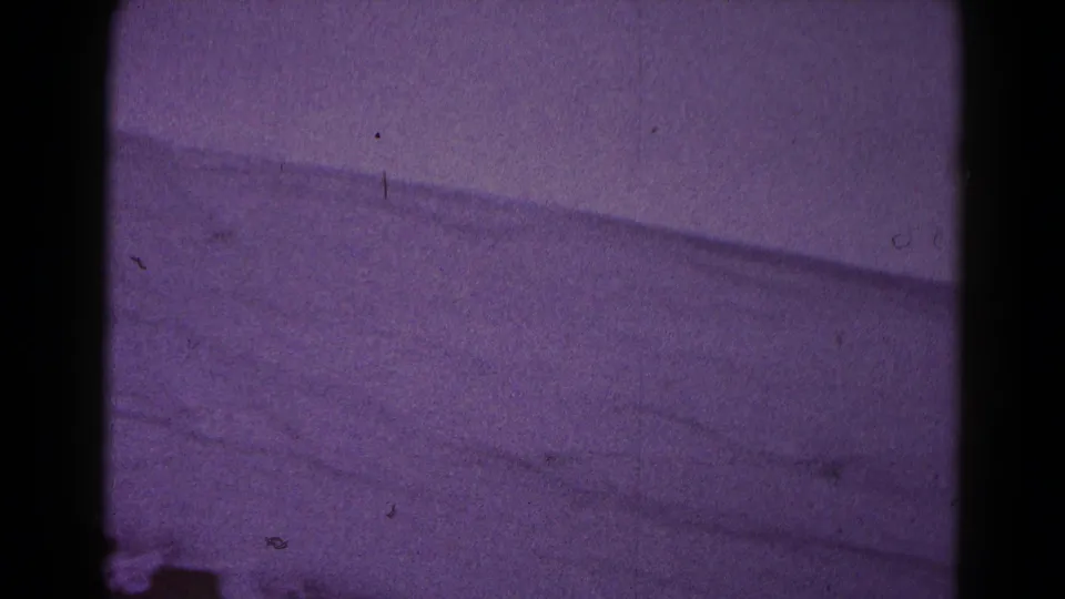 Final 1959 Hagerstown winter frame showing snow-covered ground, a dark lower edge, and aged 8mm film texture.