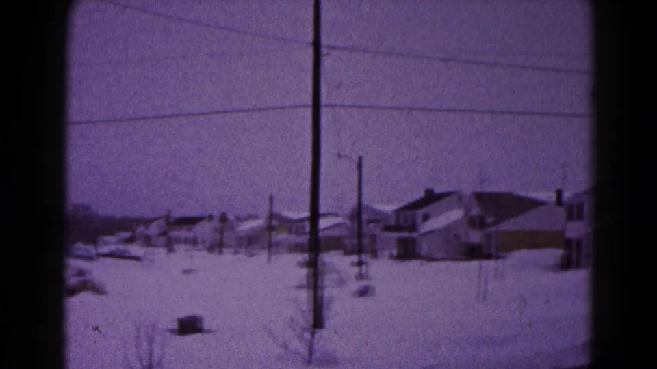 Winter street scene in Hagerstown, Maryland, with snow-covered houses, utility lines, and a distant person walking or standing outside.