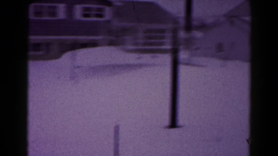 Soft 8mm view of a snow-covered residential yard with houses and a utility pole in Hagerstown metadata context.