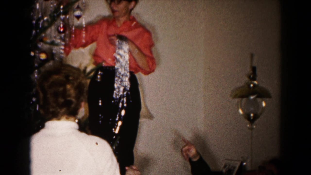 1959 Hagerstown home interior showing adults coordinating silver tinsel placement on a Christmas tree.