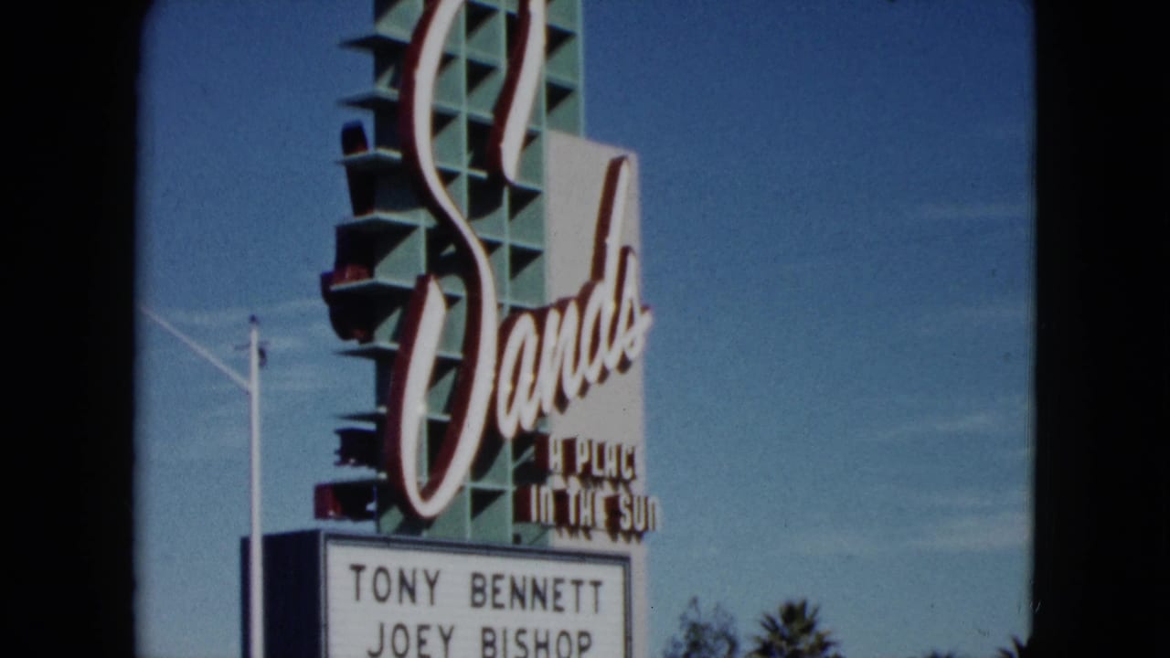 1959 Nevada home-movie frame showing the Sands sign with marquee lettering beneath it against a clear sky.
