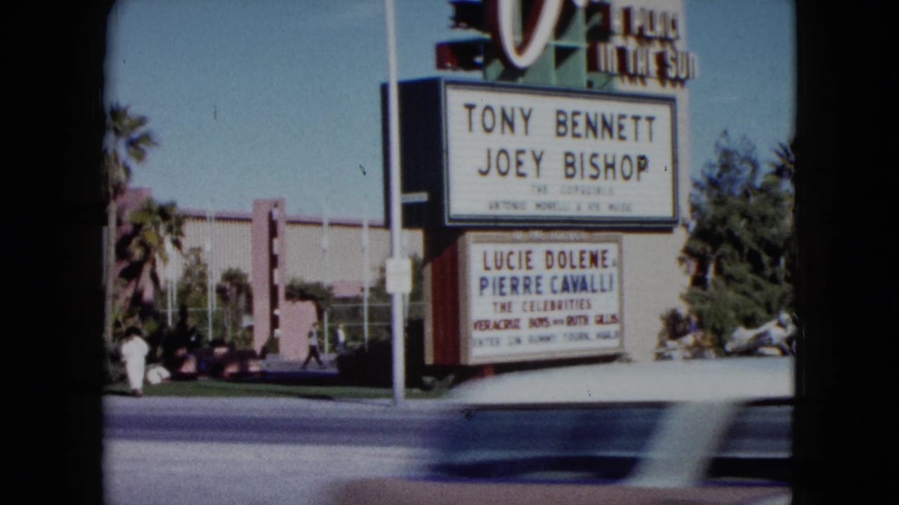 1959 Nevada 8mm frame showing a large marquee listing Tony Bennett and Joey Bishop beside palm trees and a broad street.