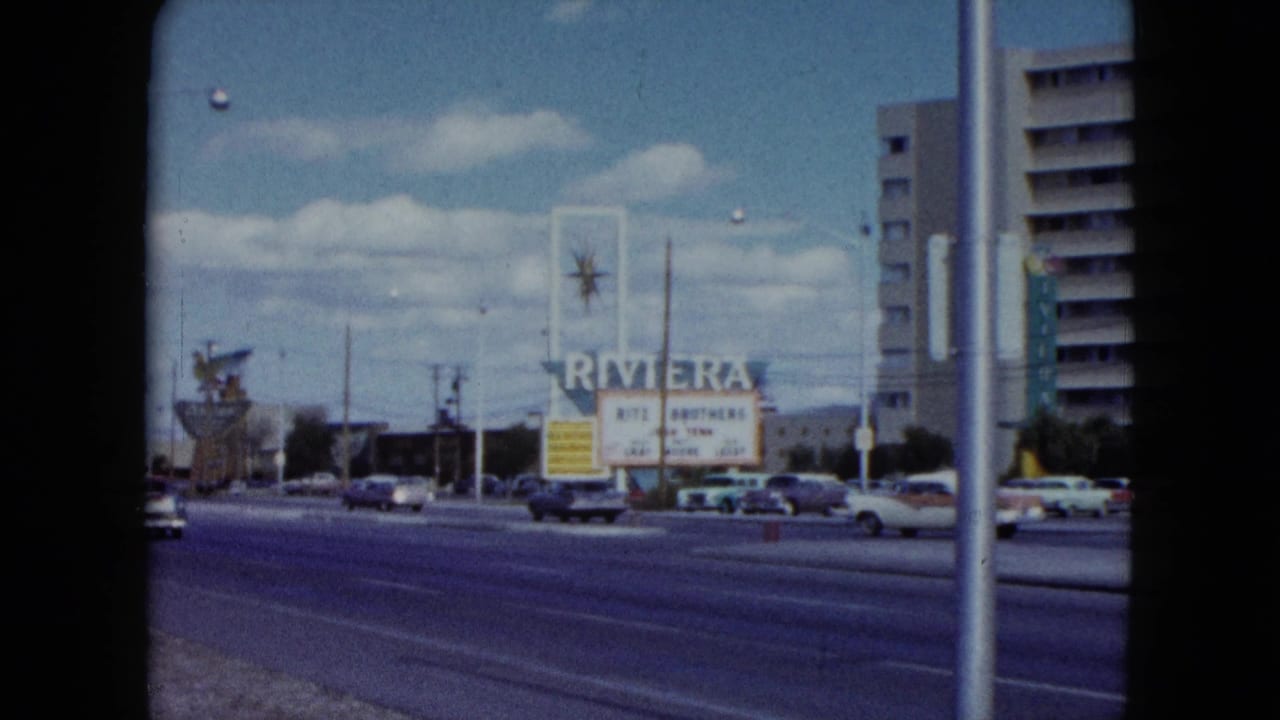Riviera sign beside a wide street with cars and hotel buildings.