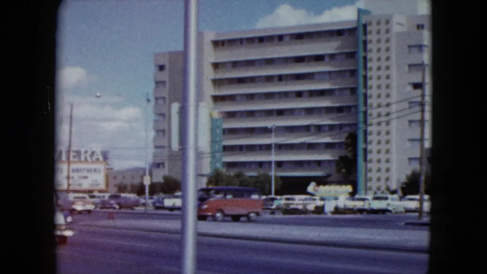 A final Nevada street view shows tall hotel buildings, the edge of Riviera signage, roadside poles, and passing 1950s-era cars.