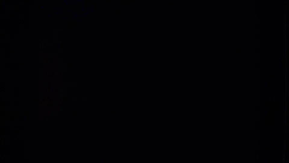 Mostly dark 8mm frame area with no clear roadside subject visible in this extracted still.