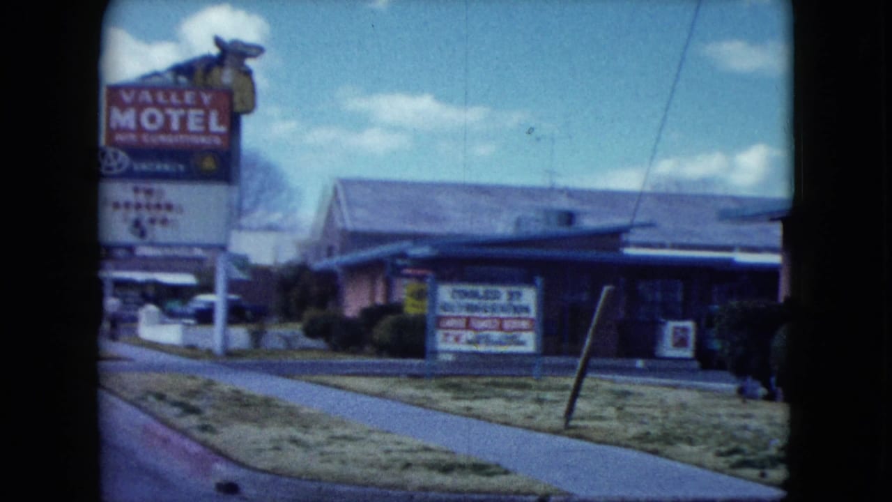 1959 Nevada roadside view of a Valley Motel sign beside a low motel building under a blue sky.
