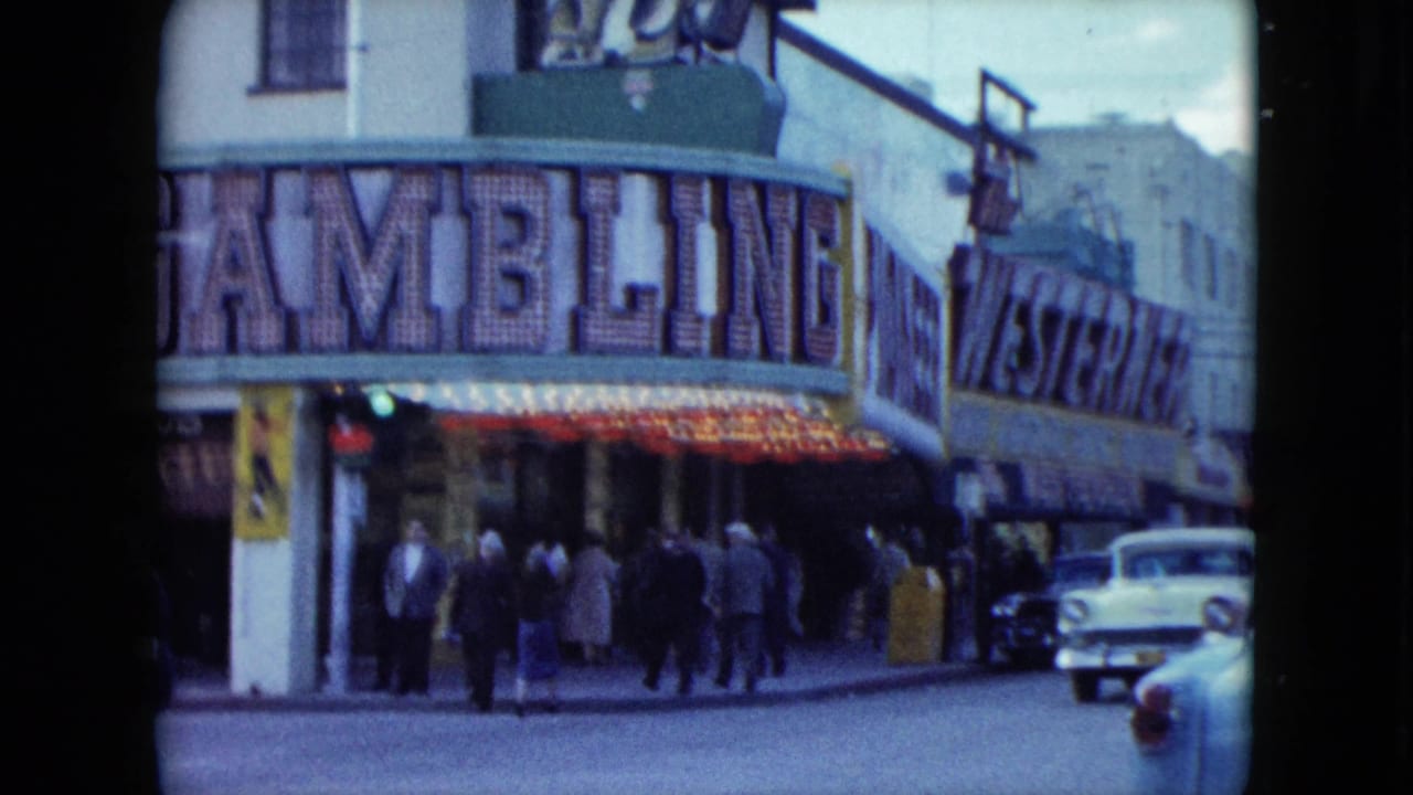 Street corner with gambling hall sign, pedestrians, and parked 1950s cars.
