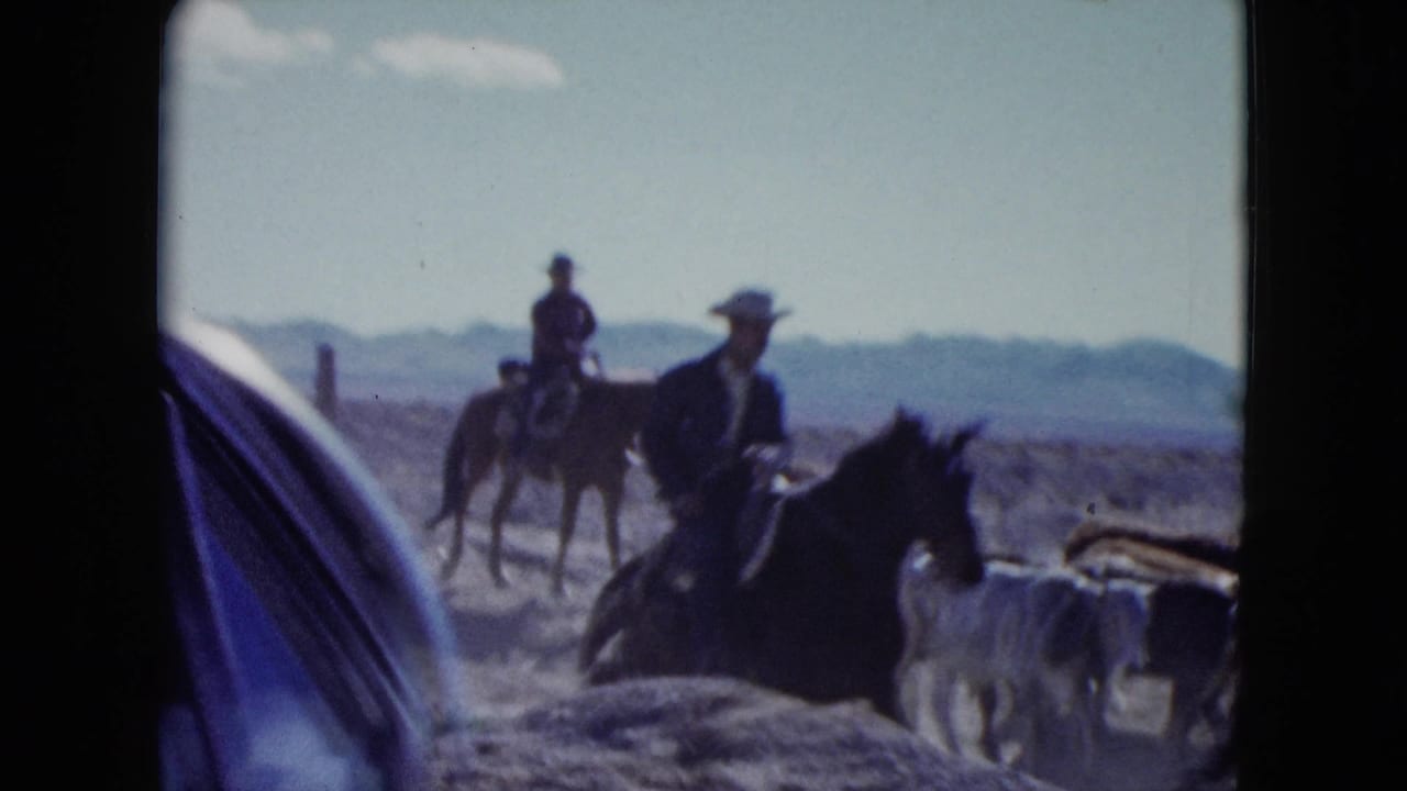 Mounted cowboys and cattle are seen in a dusty Nevada landscape near the end of the 1959 clip.