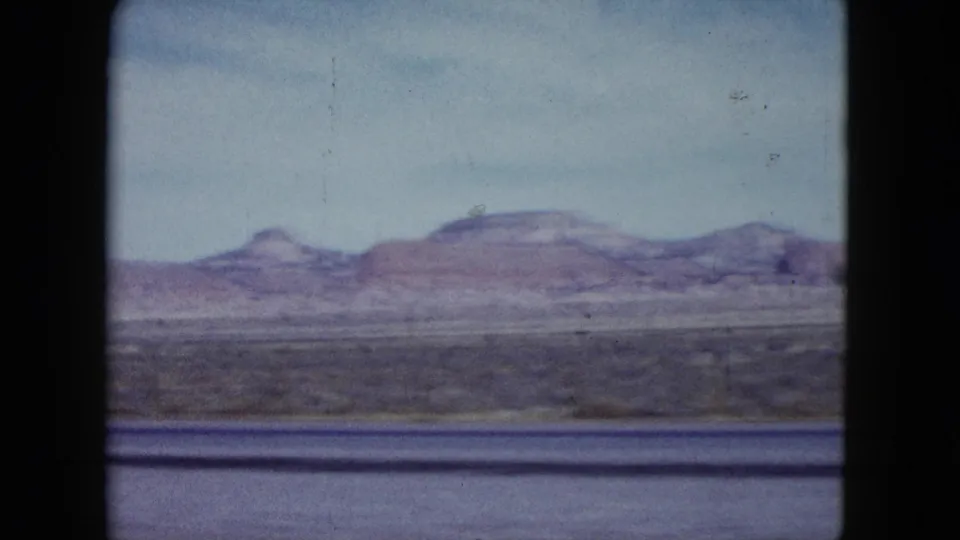 Nevada desert landscape in 1959 with low mountains, broad plain, and visible 8mm gate edges.