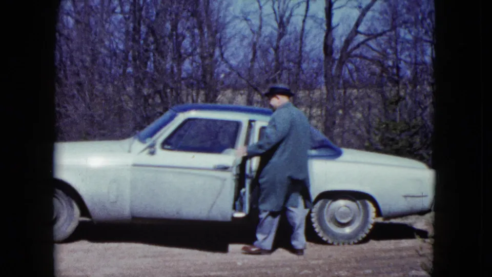 In the final frame, the man opens the door of the light-colored car, with the driveway and bare trees visible behind him.