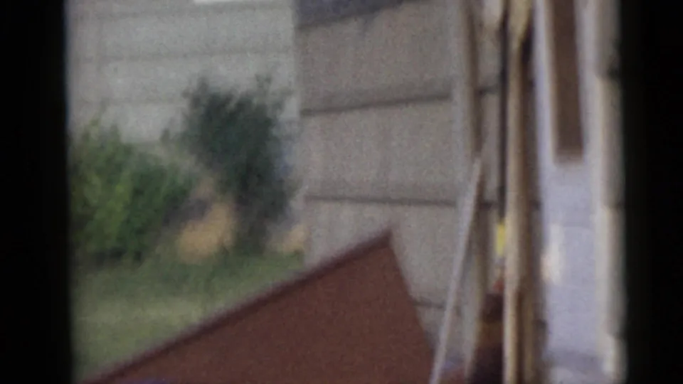 The final frame shows a soft, blurred view of the Camden backyard with shrubs, house siding, and the slanted wooden structure as figures leave view.