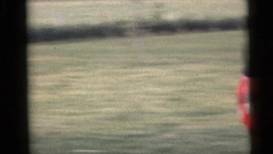 The final Camden frame shows open grass as a person in a red plaid skirt passes along the right edge.