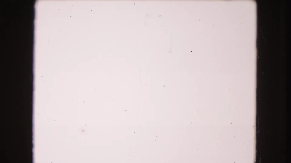 Closing 8mm frame from the 1960 Miami clip, mostly washed out with faint staining, dust, scratches, and no identifiable subjects.