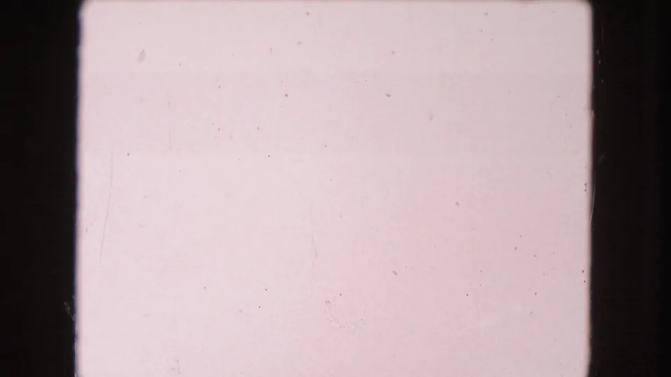 1960 Miami 8mm frame dominated by pale pink exposure, film gate edges, fine scratches, and little readable object detail.