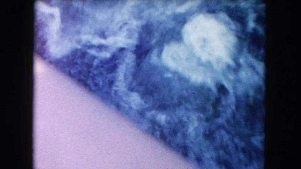 Bright 1960 Miami frame with pale blue water glare and a darker submerged area along the edge.