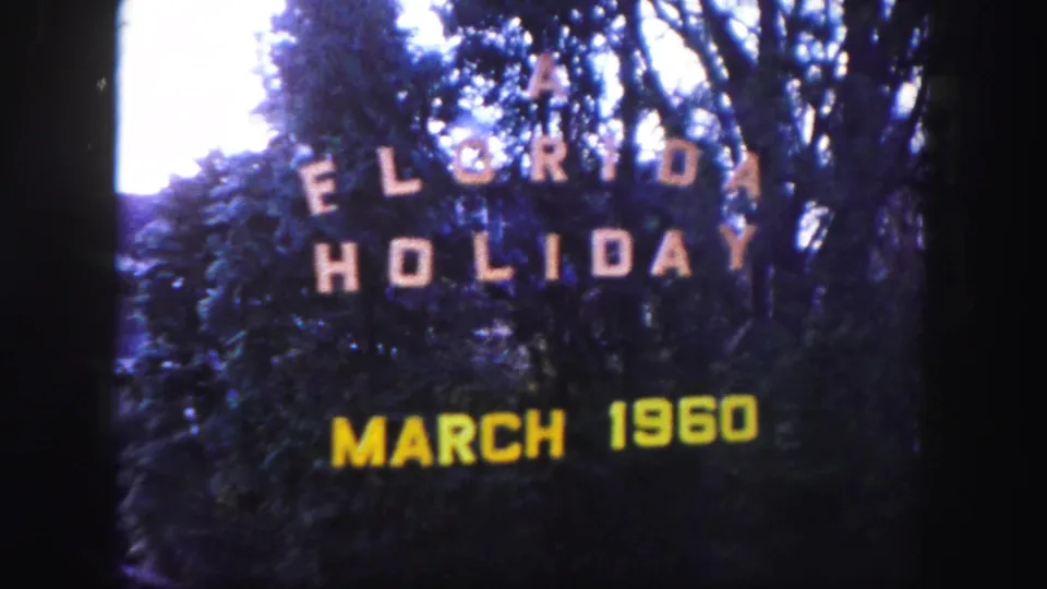 End of the short 1960 Florida title-card shot, showing yellow date text beneath white holiday lettering.