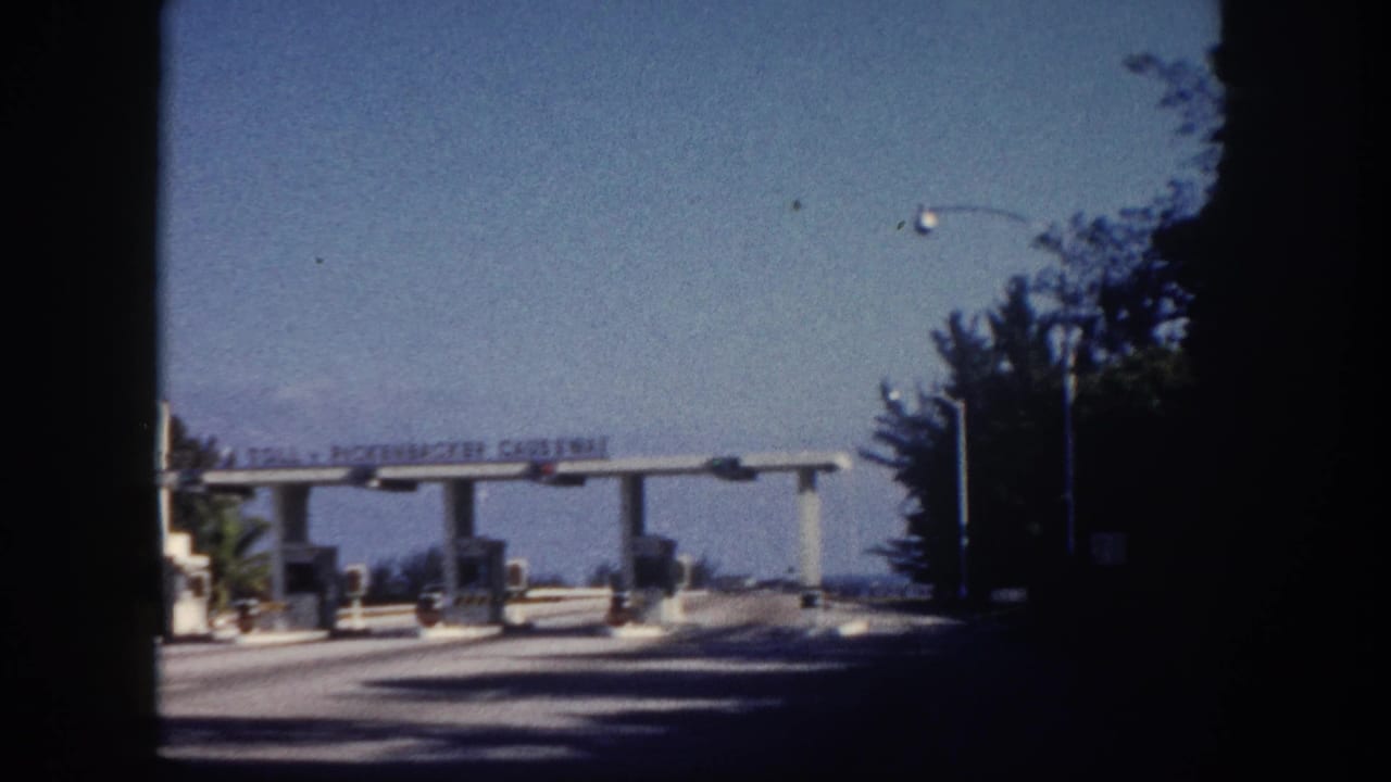 Rickenbacker Causeway toll plaza, Miami area, circa 1960, shot approaching the booth from a moving car on 8mm color film.