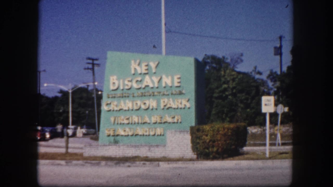 1960 roadside directional sign for Key Biscayne, Crandon Park, and Virginia Beach Seaquarium, South Florida, on 8mm color film.