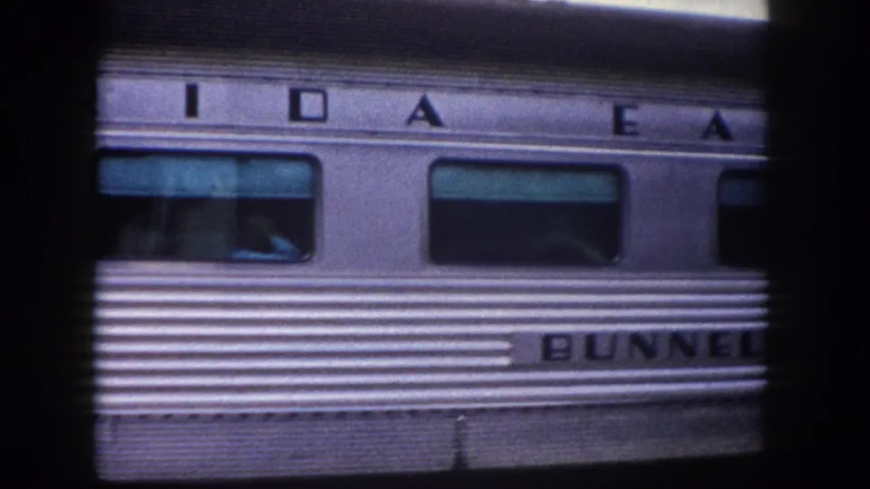 1960 Tampa area: stainless-steel railcar with 'BUNNELL' nameplate and partial lettering consistent with 'IDAHO' and 'EAST' above, captured in 8mm close-up.
