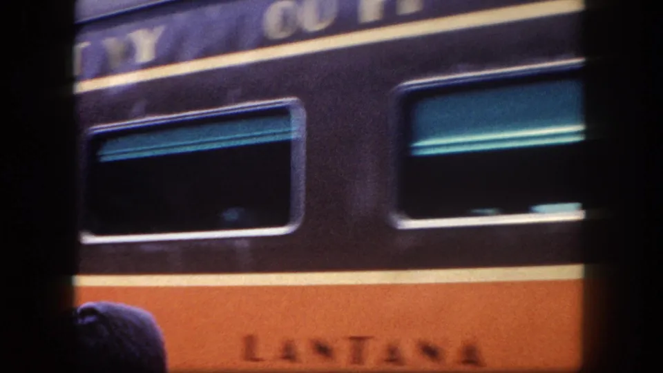 Streamliner car named 'LANTANA' in maroon and orange livery at a station platform, possibly a named Pullman car, Tampa area, circa 1960, 8mm
