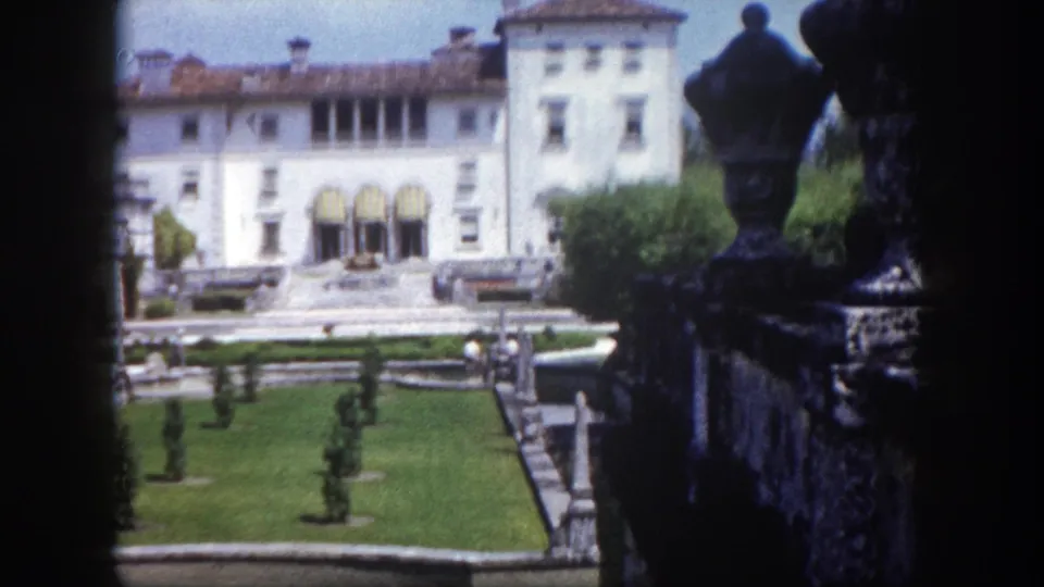 8mm home movie circa 1960 showing a white Mediterranean Revival-style estate and manicured formal garden in Tampa, Florida.