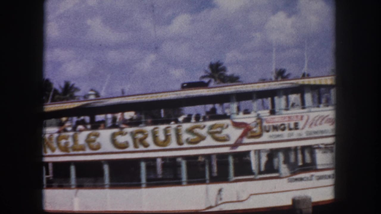 1960s Florida 'Jungle Cruise' tour vessel — likely Seminole Queen II based on metadata — with passengers on the open upper deck and palm trees behind.