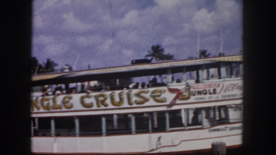 1960s Florida 'Jungle Cruise' tour vessel — likely Seminole Queen II based on metadata — with passengers on the open upper deck and palm trees behind.