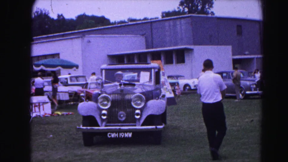Rolls-Royce on the show grounds at the 1963 Hagerstown, Maryland classic car show; flat-roofed modernist building and additional vehicles visible beyond.