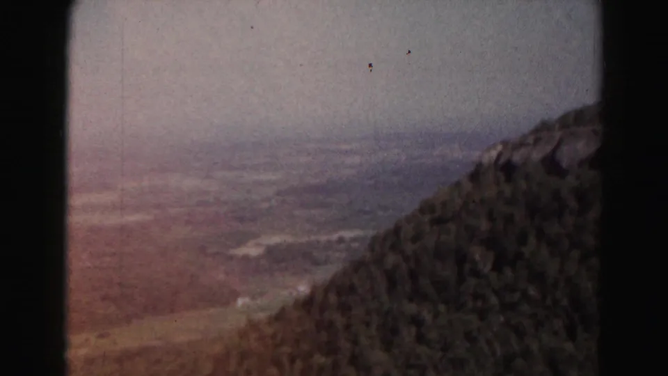 The mountain-side panorama continues across a hazy valley near Hagerstown, Maryland, with soft color and visible 8mm film grain.