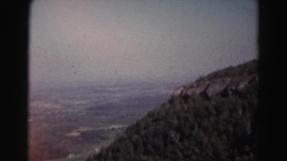 A final 1963 8mm frame from the Maryland overlook shows the forested mountainside and distant valley softened by haze and film fade.