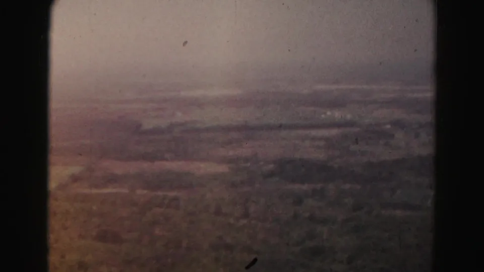 1963 aerial footage near Hagerstown shows muted fields, wooded patches, and a hazy rural horizon.