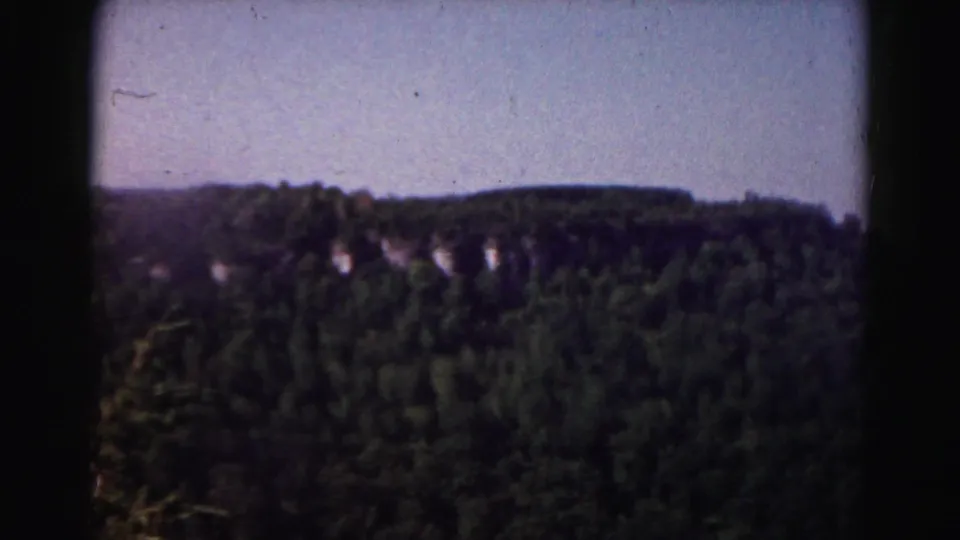 Soft 8mm view of a forested mountain ridge during a 1963 Maryland-area road trip.