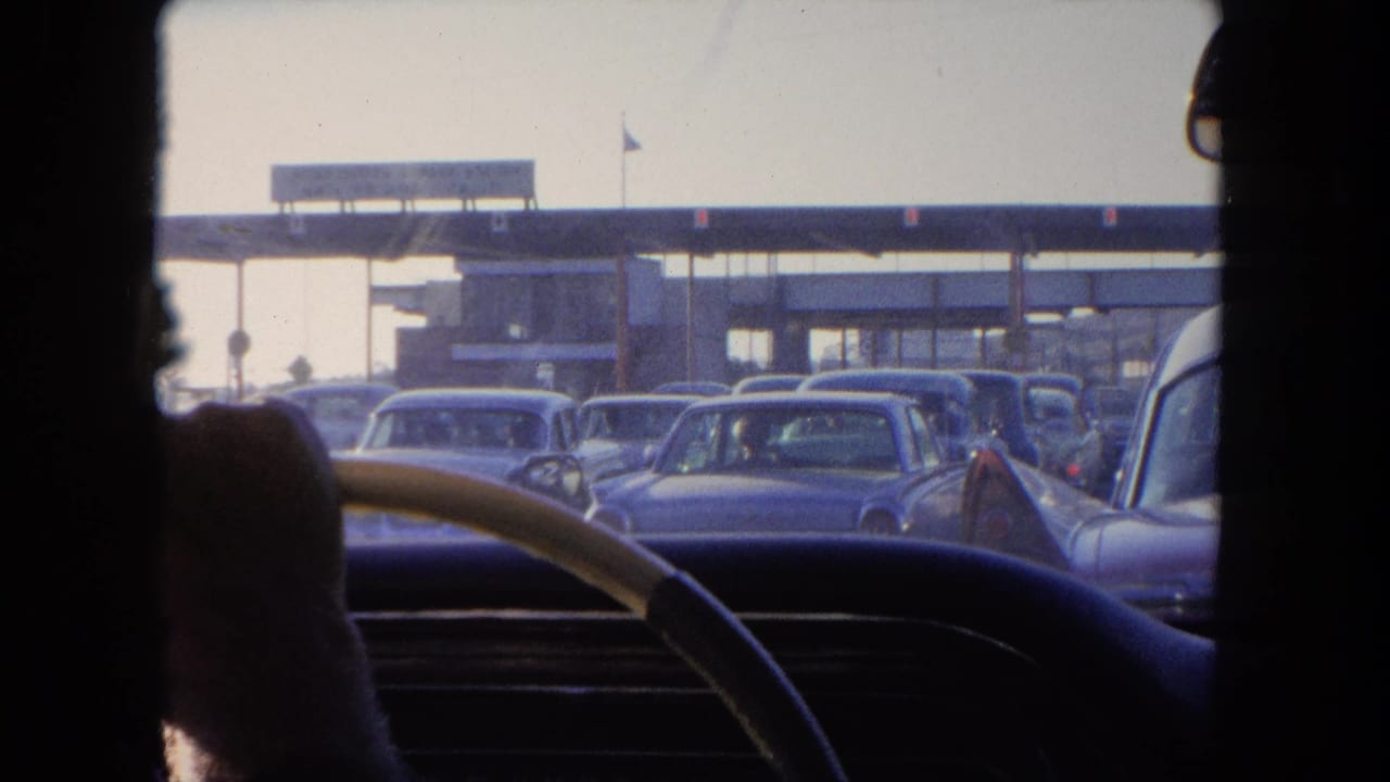 View from inside a car toward traffic near a waterfront structure.