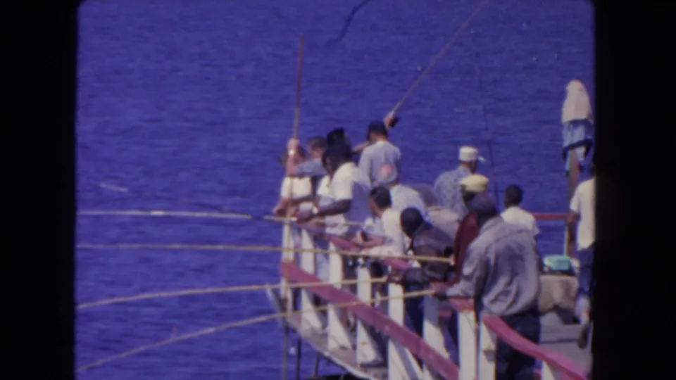 The final frame shows a wider group of men fishing from the San Diego pier, with rods lifted and extended over the water.