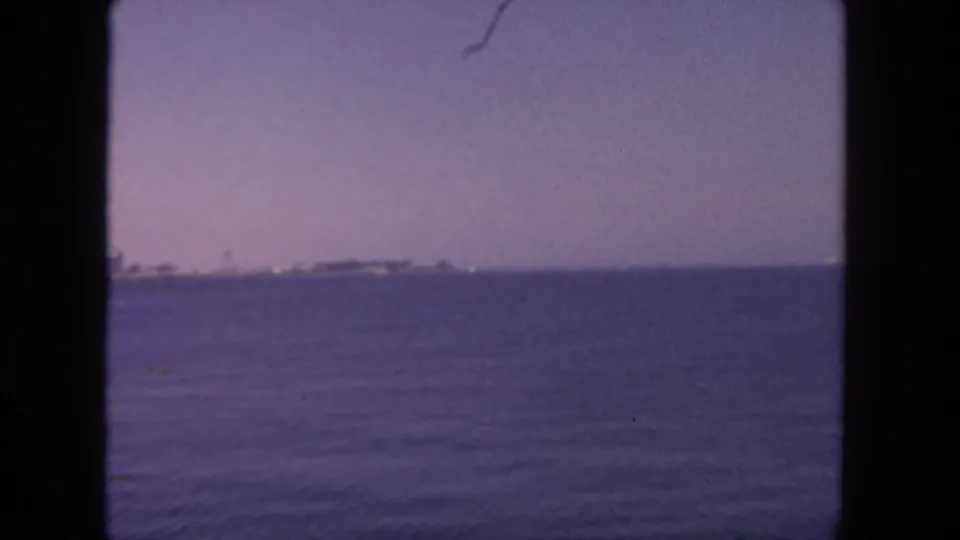 Wide 8mm view of San Diego harbor water with a faint shoreline and ships on the horizon.