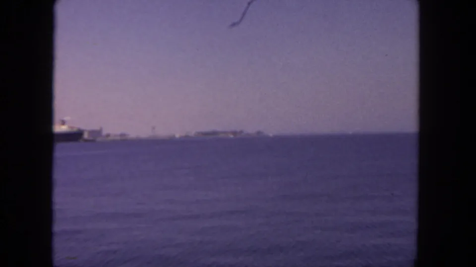 End frame of the 1962 8mm coastal view, showing mostly water, hazy sky, and a distant shoreline likely around San Diego.