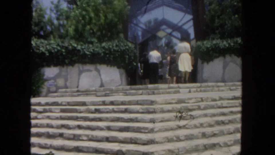 A closer 1962 San Diego view shows visitors climbing broad stone steps toward the glass-and-stone building entrance.
